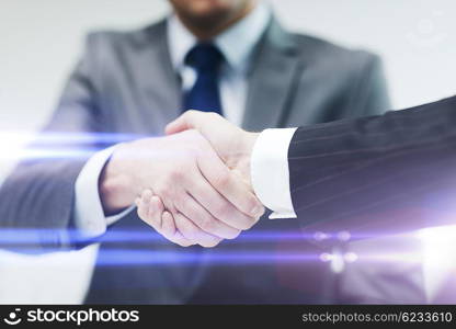 businesss and office concept - two businessmen shaking hands in office. two businessmen shaking hands in office