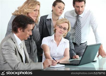Businessteam around a laptop