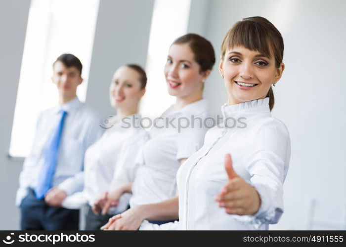 Businessteam holding hands. Image of four businesspeople standing in row. Partnership concept