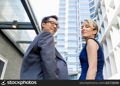 Businessteam members standing next to each other in business district. Serious about success and determined