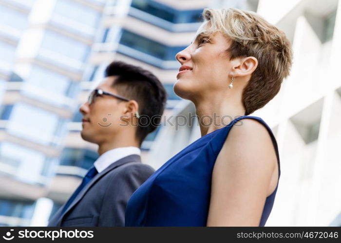 Businessteam members standing next to each other in business district. Serious about success and determined