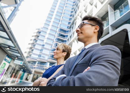 Businessteam members standing next to each other in business district. Serious about success and determined