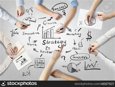 Businessteam working in collaboration. Top view of people hands drawing business strategy successful plan