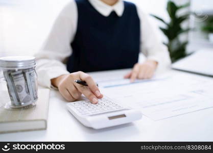 Businesswoman Accountant analyzing investment charts Invoice and pressing calculator buttons over documents. Accounting Bookkeeper Clerk Bank Advisor And Auditor Concept.