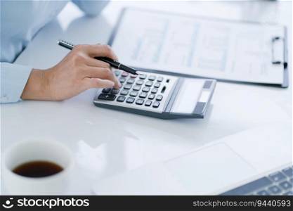 Businesswoman Accountant analyzing investment charts Invoice and pressing calculator buttons over documents. Accounting Bookkeeper Clerk Bank Advisor And Auditor.