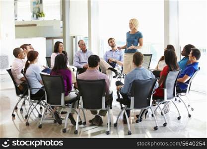 Businesswoman Addressing Multi-Cultural Office Staff Meeting
