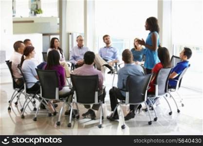 Businesswoman Addressing Multi-Cultural Office Staff Meeting