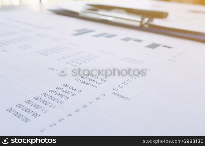 Businesswoman analyzing investment charts and pressing calculator buttons over documents. Accounting Concept