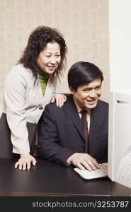 Businesswoman and a businessman using a computer