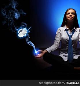 Businesswoman and a cup of coffee. Businesswoman sitting and mediatating and a cup of coffee