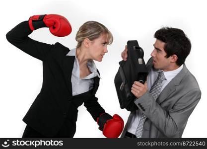 Businesswoman and businessman fighting