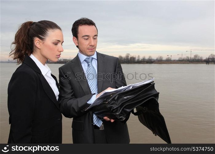 Businesswoman and businessman meeting outdoors