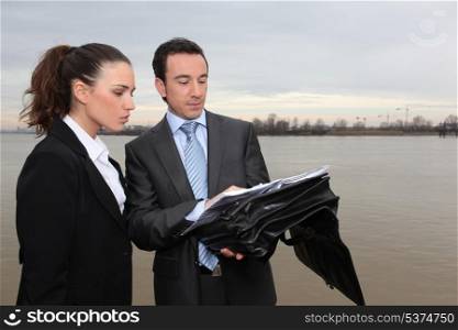 Businesswoman and businessman meeting outdoors