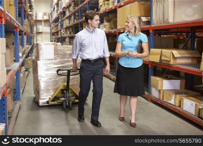 Businesswoman And Colleague In Distribution Warehouse