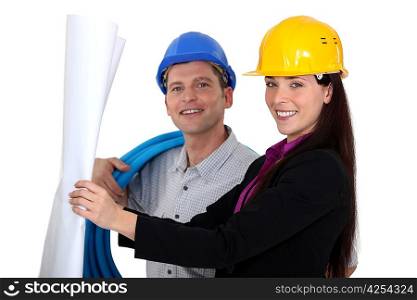 businesswoman and craftsman looking at a blueprint