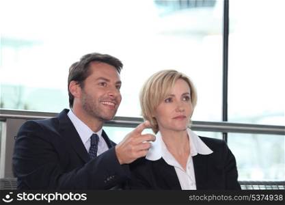 Businesswoman and man pointing