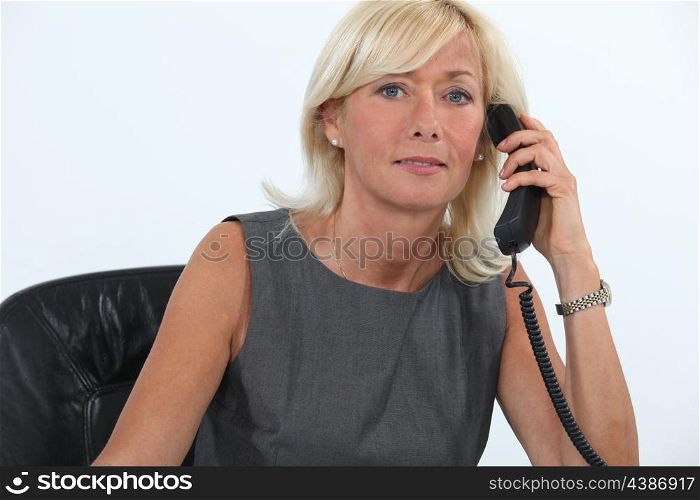 Businesswoman answering the telephone