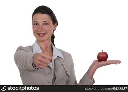Businesswoman approving an apple