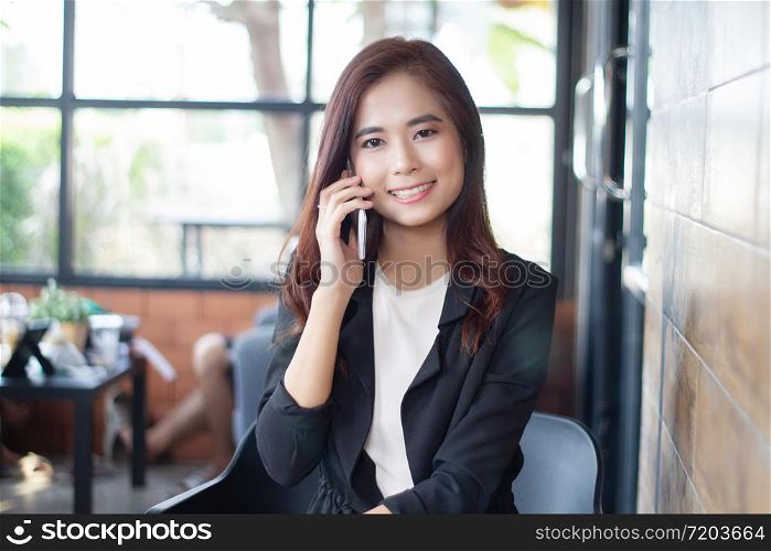 Businesswoman asian using phone for celling and texting on her mobile phone
