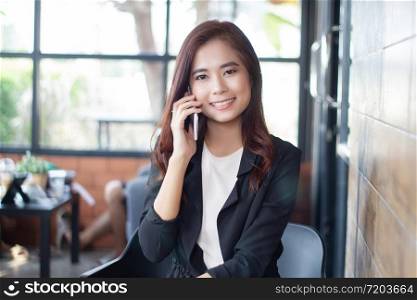 Businesswoman asian using phone for celling and texting on her mobile phone