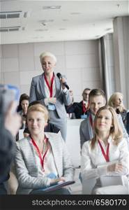 Businesswoman asking questions during seminar