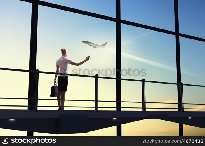 Businesswoman at airport. Image of businesswoman at airport looking at airplane taking off