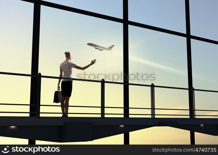 Businesswoman at airport. Image of businesswoman at airport looking at airplane taking off