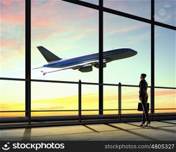 Businesswoman at airport. Image of businesswoman at airport looking at airplane taking off