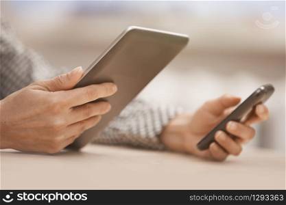 Businesswoman at office with digital tablet and smartphone