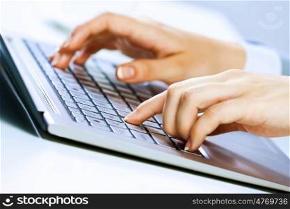 Businesswoman at work. Close up image of businesswoman hands typing on keyboard