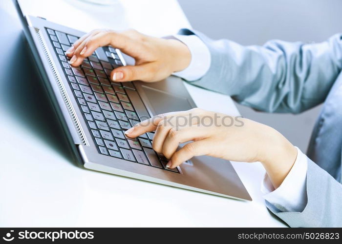 Businesswoman at work. Close up image of businesswoman hands typing on keyboard