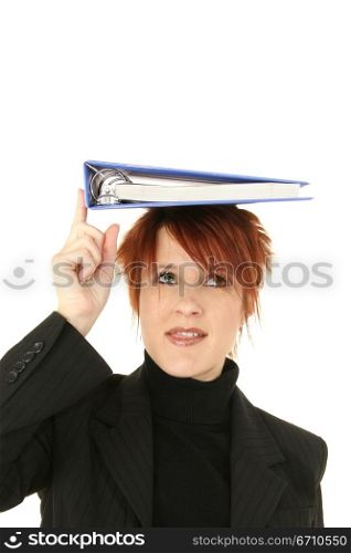 Businesswoman balancing a notebook on her head