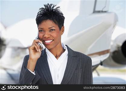 Businesswoman Beside an Airplane