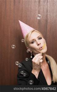 Businesswoman blowing bubbles