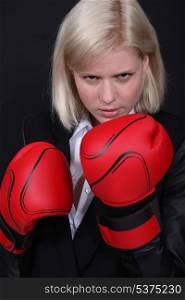 Businesswoman boxing