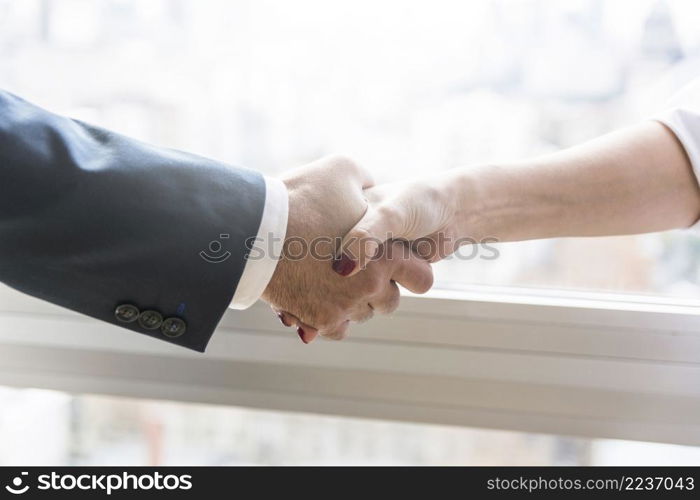 businesswoman businessman shaking hands