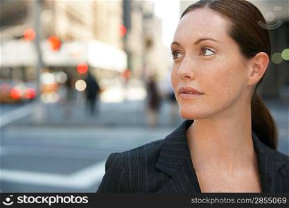 Businesswoman by intersection in street