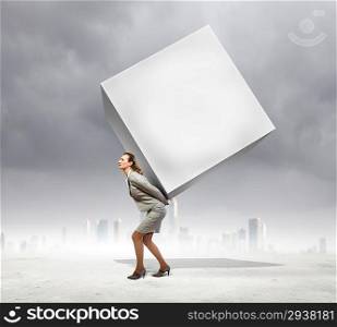 Businesswoman carrying cube