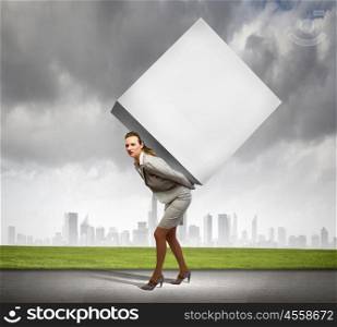 Businesswoman carrying cube. Image of businesswoman carrying big white cube on her back. Place for text