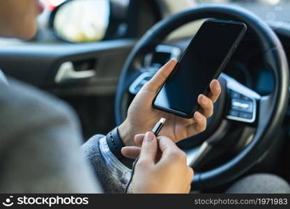 businesswoman charging her phone car. High resolution photo. businesswoman charging her phone car. High quality photo