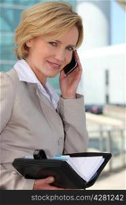 Businesswoman checking her diary smiling