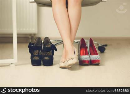 Businesswoman choosing comfortable shoes instead of high heels