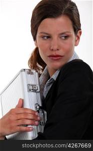 Businesswoman clutching metal briefcase