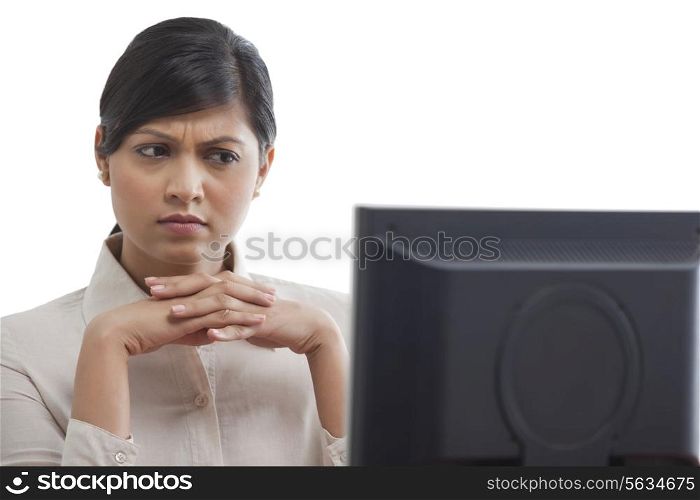 Businesswoman concentrating while looking at monitor screen