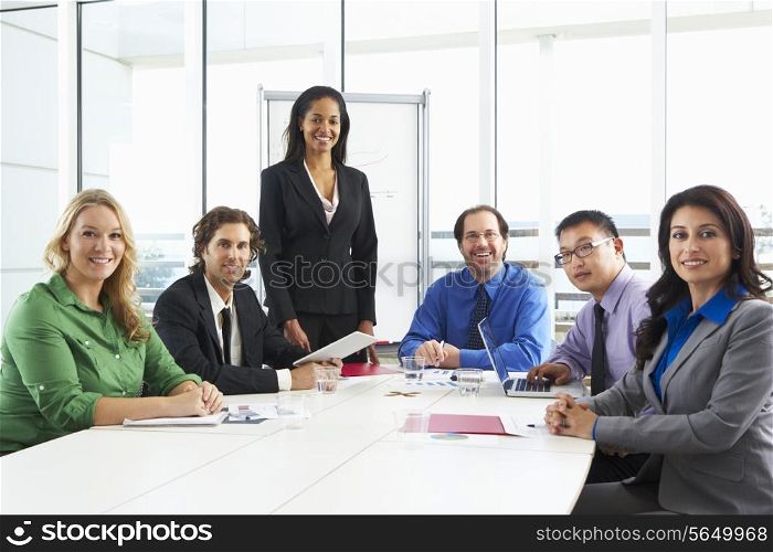 Businesswoman Conducting Meeting In Boardroom