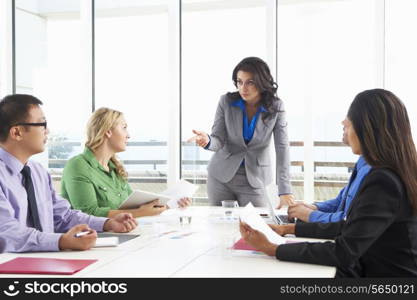 Businesswoman Conducting Meeting In Boardroom