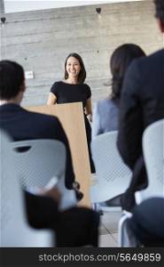 Businesswoman Delivering Presentation At Conference