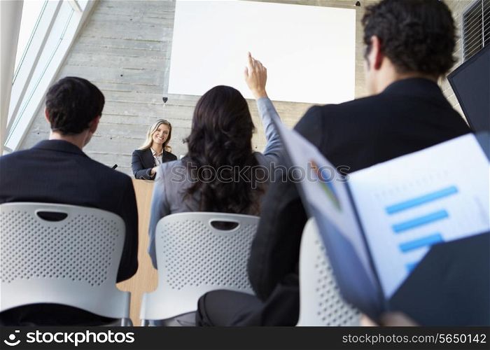 Businesswoman Delivering Presentation At Conference