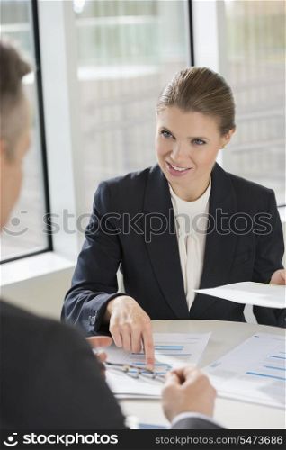 Businesswoman discussing with colleague at cafeteria