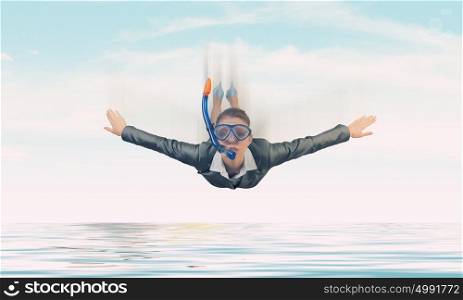 Businesswoman diver in free fall. Young businesswoman in suit and diving mask flying in sky